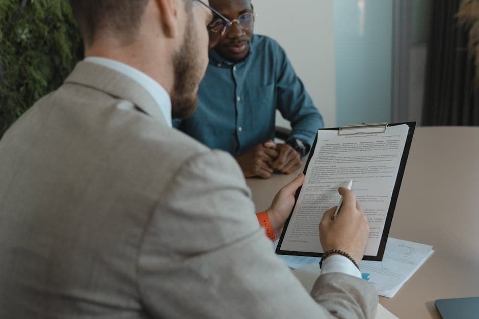 Recruiter reviewing a resume at a desk with multiple documents