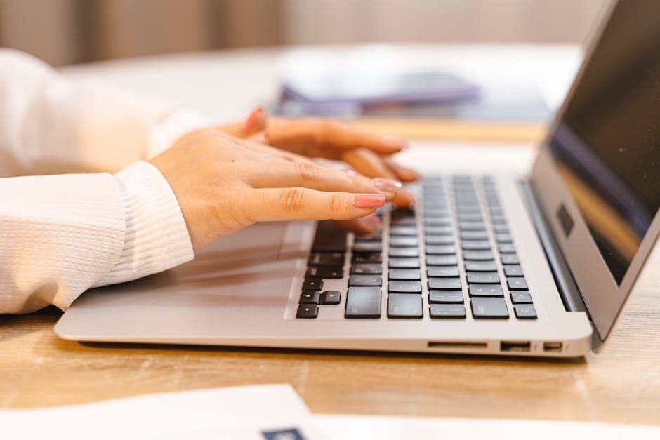 Person editing their resume on a laptop at a clean desk